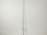 a black broom sitting on top of a floor next to a white wall