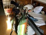 a bag of golf clubs on the bed in the room