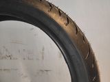 a close up of a tire on a wall with a white background
