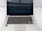 an open laptop computer sitting on top of a white table