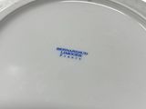 an image of a close up of a white plate with a blue logo on it