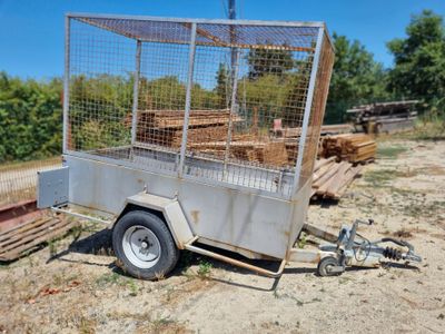 a small trailer with a cage on the back of it