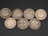 six silver coins with the names of different countries on them
