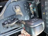 a close up of a car ' s dashboard with a steering control