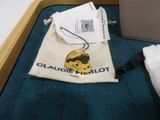 a bag with a gold coin on it next to a bag of luggage
