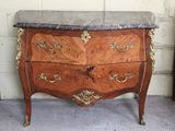 a marble top chest of drawers on display in a room