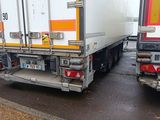 two trucks that are parked on the side of the road