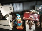 a toy duck that is sitting on a shelf next to other toys