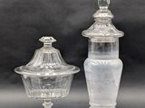 two clear glass jars with lids on a gray surface