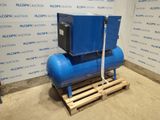 a blue compressor sitting on top of a pallet in front of a wall
