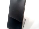 a broken cell phone sitting on top of a stand
