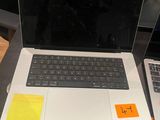 two laptops sitting on a table with sticky notes on them