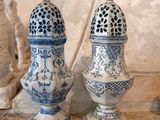 three blue and white vases sitting on a shelf