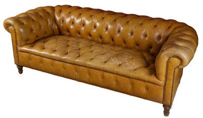 brown leather sofa with buttoned arms and legs
