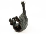 a bronze sculpture of a bird on a white surface