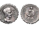 a close up of two silver coins on a white surface