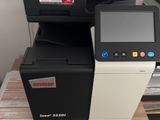 a printer that is sitting on top of a stack of boxes