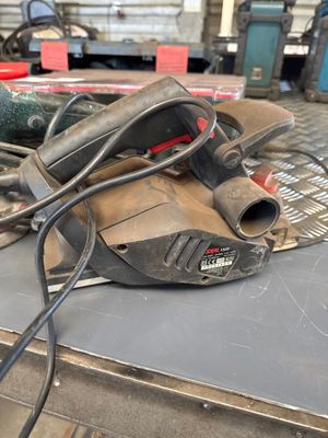 a sander on a table with other tools on it