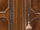 a wooden door with a handle and a flower on it