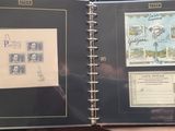 an open book with stamps on it on a table