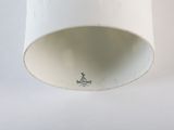 a white cup that has a small sticker on it