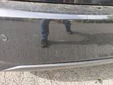 a reflection of a person standing on the side of a car