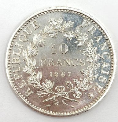 a close up of a coin on a white surface