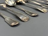 cinq cuillères et deux cuillères posées sur une table