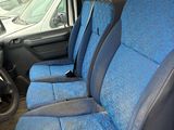 a blue seat cover in the back of a van
