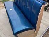 a blue bench made out of cardboard on the ground