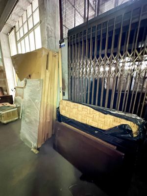 a bed that is sitting in a room with a fence