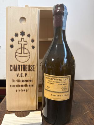 Des bouteilles de vin sont posées sur une table, à côté d'une caisse en bois