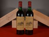 two bottles of wine sitting next to each other on a table