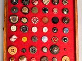 a picture of a display of buttons in a wooden frame