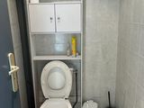 a white toilet sitting in a bathroom next to a blue door