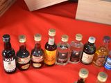 bottles of alcohol are lined up on a red table cloth