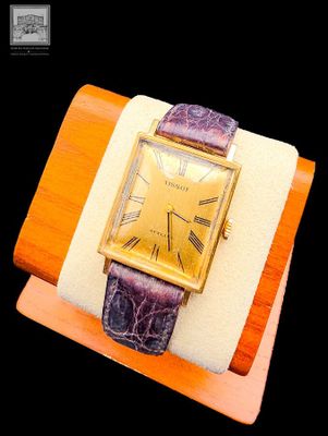 a watch that is sitting on top of a wooden stand