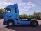a blue truck that is parked in the parking lot