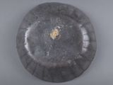 a black plate with a yellow spot on it