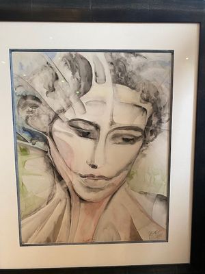 tableau représentant le visage d'une femme, dans un cadre noir sur fond blanc