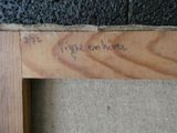a piece of wood that has writing on it