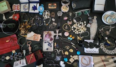 a table with a lot of jewelry and other items on it