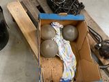 a box of balls sitting on a pallet next to a pair of shoes