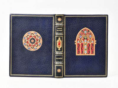 a blue book with a picture of a stained window on it