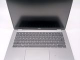 an open laptop computer sitting on top of a white table