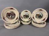 four plates with a picture of a town on them on a table