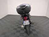 a motorcycle that is parked in a room with a checkered floor