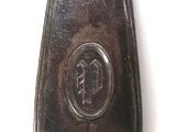 a silver spoon with a black handle on a white surface