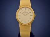 an image of a close up of a wrist watch on a blue background