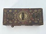 a small wooden box with a coin inside of it